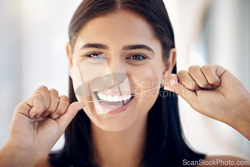 Image of Floss, oral care and dental with healthy teeth and woman cleaning mouth in portrait, gum health and Invisalign. Hands, face and hygiene with grooming and clean, fresh breath, flossing and whitening.