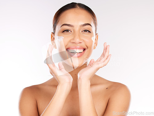 Image of Skincare, beauty cream and face of woman with lotion for hydration, glow and healthy skin on studio background with a smile. Portrait of aesthetic model happy about cosmetics, makeup and dermatology