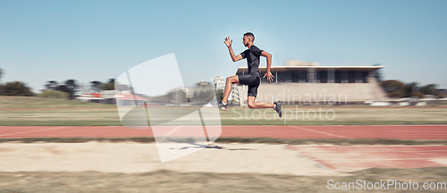 Image of Runner, man jump and sports stadium for marathon training, fitness workout or wellness exercise on track. Athlete, speed and running energy or jumping for olympics high jump performanc and challenge