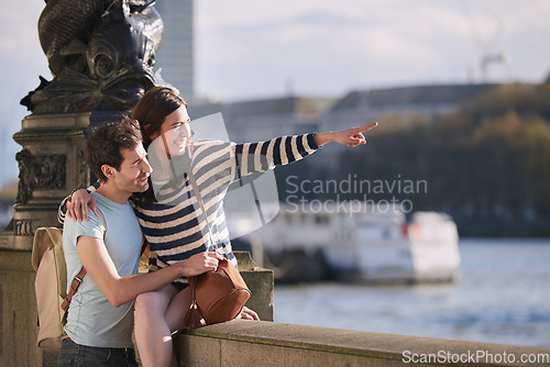 Image of Travel, love and honeymoon with a young couple pointing while sightseeing on an overseas trip abroad together. Water, city and summer with a man and woman bonding or traveling in a foreign country