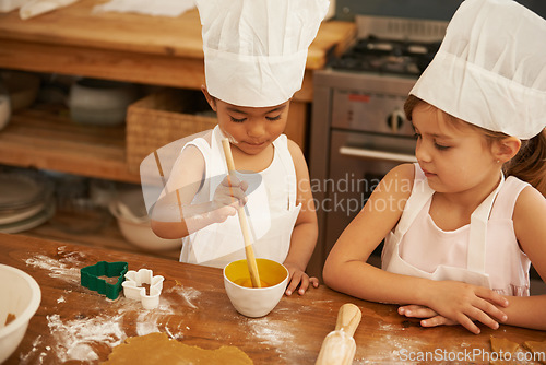 Image of Children, learning and baking in a kitchen with girls bonding, curious and mixing egg for cake in their home. Kids, cooking and siblings having fun with cookies, recipe and development activity