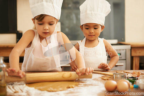 Image of Baking, helping and children in the kitchen with dough for cookies together in a house. Cooking, baker and young girl friends making baked food, breakfast or a snack with help in a bakery or home