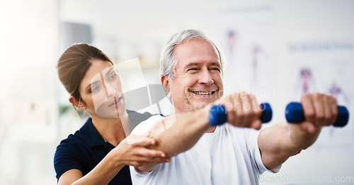 Image of Physiotherapy, senior man and dumbbell exercise, injury rehabilitation or workout at health clinic. Happy elderly patient, woman physiotherapist or muscle training for strong body, care or fitness