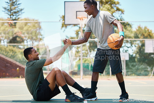 Image of Basketball, sports and teamwork, helping hand and support, respect and assistance in competition training games. Happy basketball player holding hands with friend, trust and kindness on outdoor court