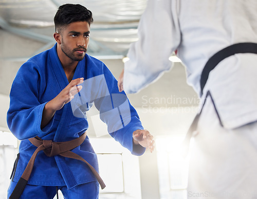 Image of Martial arts, karate and student learning safety or self defense from a taekwondo expert or master in a dojo. Focus, fitness and fighting instructor coaching, teaching or fighting a healthy man