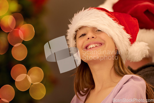Image of Portrait, child and christmas in a santa hat to celebrate the festive season with childhood joy and happiness. Holiday, xmas and little girl or kid smiling while celebrating a tradition in december