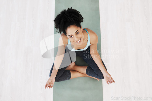Image of Fitness, yoga and girl portrait top view on ground with mat for wellness, happiness and health. Spirituality, self care and healthy mindset of black woman relaxed on floor for awareness exercise.