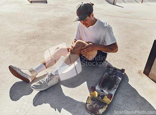 Image of Skateboard, knee and injury with a sports man holding his leg joint in pain after a fall or accident outdoor. Fitness, skatepark and exercise with a male athlete suffering in agony while skating