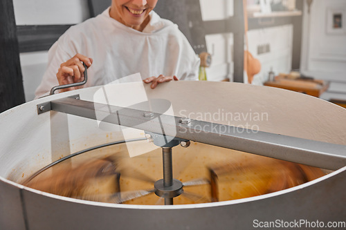 Image of Machine, beekeeper and honey in production in a factory at sustainable, agriculture and agro bee farm. Mixer, manufacturing and woman farmer in warehouse to produce organic, natural and raw honeycomb