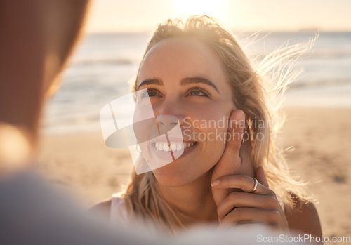 Image of Affection, love and couple at the beach for a date, honeymoon and quality time by the sea. Travel, relax and face of a woman with an embrace from a man while on holiday by the ocean to relax