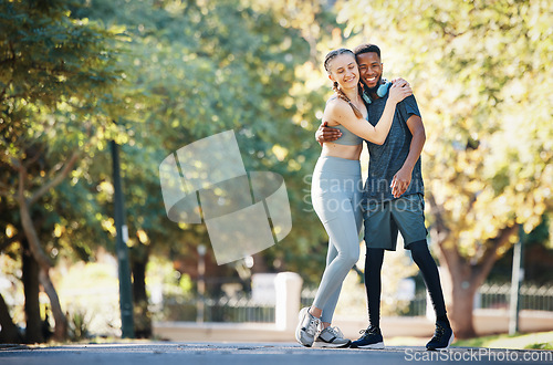 Image of Workout, couple and hug in park portrait for exercise, fitness and walk break with smile for affection. Interracial, love and wellness of happy people dating on cardio rest together in New York.