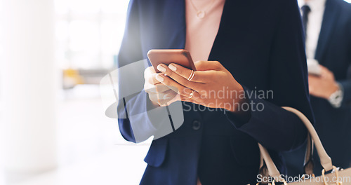 Image of Business woman, phone and hands texting in communication, social media or chatting at the office. Hand of female employee reading, typing or browsing on mobile smartphone at the workplace