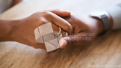 Image of Holding hands, support and trust with couple and love, solidarity, comfort and care with hands zoom against wood table. Partnership, marriage and relationship, helping hand and commitment closeup.