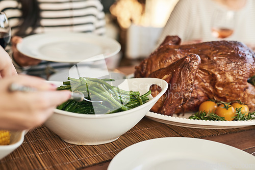 Image of Food, thanksgiving and hands serving lunch at table with care for family, friends and loved people. Celebration, turkey and traditional festive holiday meal for togetherness, thanks and gratitude.