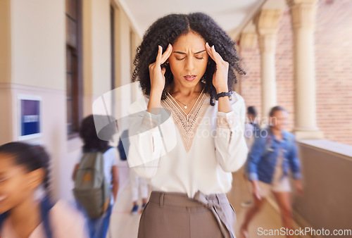 Image of Headache, tired and stress teacher in school with fast children thinking of work stress, education mindset and management challenge in hall. Black woman sad, angry and pain with speed or busy campus