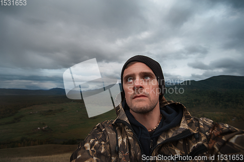 Image of Caucasian man in the mountain making selfie