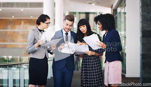 Image of Business people team reading paperwork, documents and planning strategy, financial information or company analytics in modern office. Diversity, corporate workers and paper reports, analysis and idea