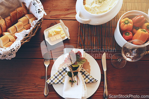 Image of Above, lunch celebration and food on table for holiday, Sunday dinner or party. Table setting, nutrition and feast at a dining room table for a dinner party, fine dining and foods at a place setting