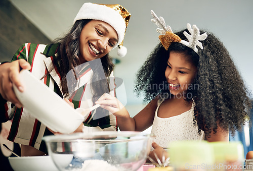 Image of Christmas, love and girl baking with mother in kitchen to make festive cookies, biscuits and treats. Black family, love and mom bake with child enjoying festival celebration, holiday and vacation