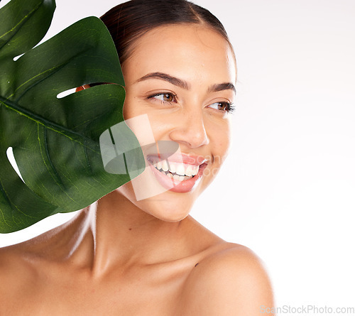 Image of Woman, face or skincare glow with plant in organic healthcare wellness, vegan dermatology or healthy Brazilian cosmetics. Smile, happy or beauty model with monstera leaf on studio background mock up