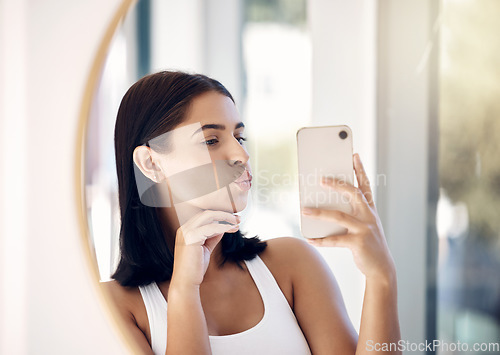 Image of Selfie, phone and woman with mirror in bathroom for beauty, skincare and social media. Hygiene, self care and cleaning with girl and pout in reflection the morning for technology, mobile and internet