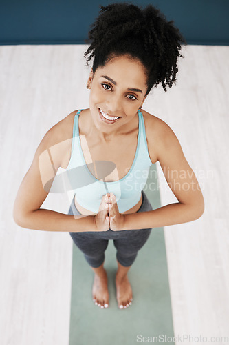 Image of Portrait, black woman and namaste meditation in yoga studio, fitness club and exercise motivation, healthy lifestyle or mindfulness. Happy young african female, meditate and training workout to relax