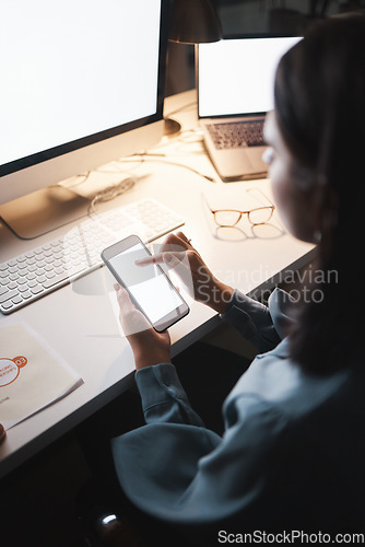 Image of Business woman, phone and green screen, branding space and mockup for advertising, social media and internet at night in office. Corporate worker, working late and texting contact on app with mock up