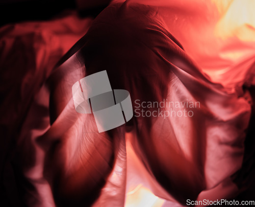 Image of Red lighting, dark and person with fabric for depression, sadness and mental health problems. Creative art, psychology and sheet over head for loneliness, isolation and adult suffering with anxiety