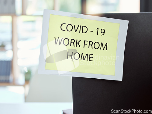 Image of Covid, sign and work from home at the office for health and safety rules or regulations during pandemic. Label post of corona virus restrictions for working remote, quarantine or control at workplace