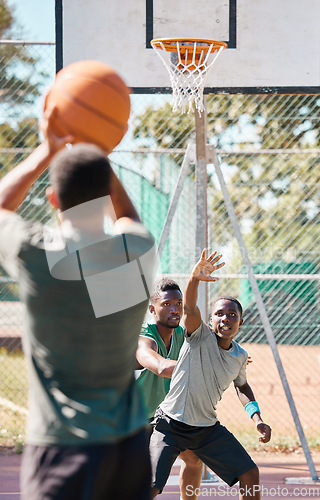 Image of Basketball court, games and competition, friends and outdoor sports, fitness and energy of goals, performance and action. Basketball player group, men and team challenge, defending and urban training