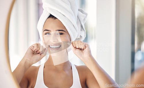 Image of Dental floss, teeth and woman in mirror of bathroom for shower, cleaning and morning routine. Beauty, cosmetics and wellness with face of girl at home for oral hygiene, fresh breath and mouth health