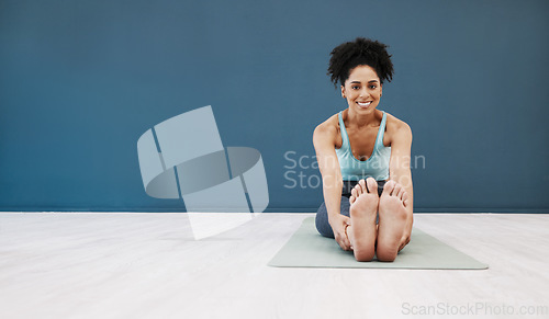 Image of Yoga, portrait and black woman with wall mockup for fitness, pilates and wellness marketing or advertising space. Blue brand, gym or studio with happy girl in portrait stretching or cardio on floor