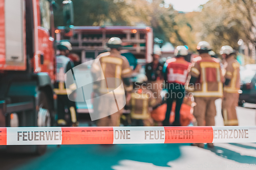 Image of Team of firefighters by firetruck on accident location.