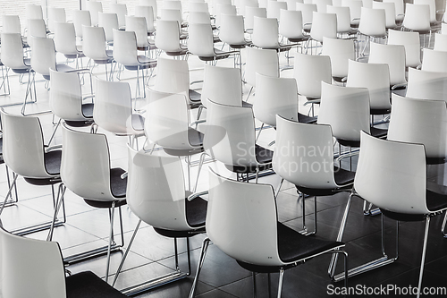 Image of Empty white chairs in contemporary conference hall