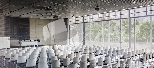 Image of Empty white chairs in contemporary conference hall