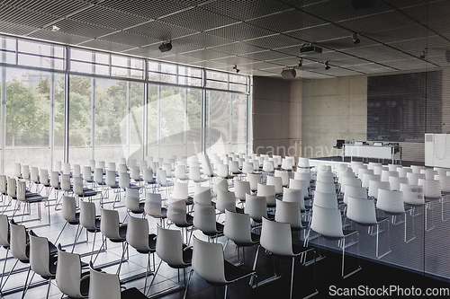 Image of Empty white chairs in contemporary conference hall