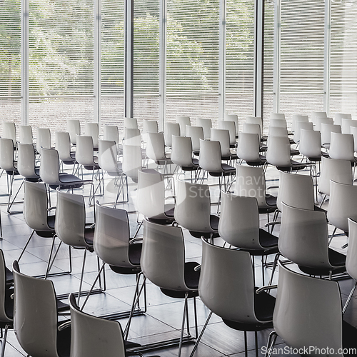 Image of Empty white chairs in contemporary conference hall