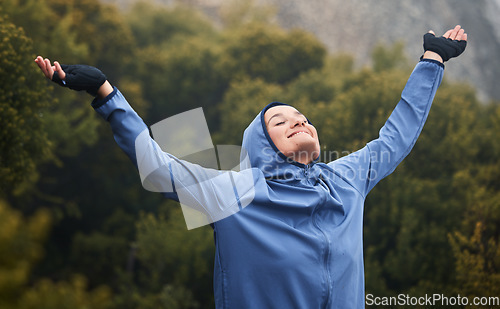 Image of Fitness, peace and woman with gratitude, freedom and success with hands up in spiritual prayer or worship. Winter, forest and healthy girl with a happy smile after training or running in nature