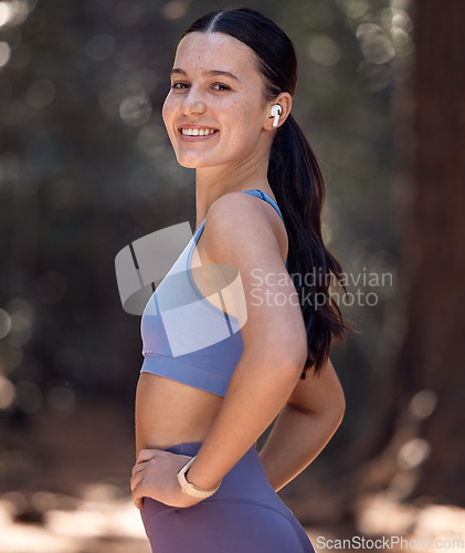 Image of Happy woman, portrait and park fitness, runner and workout in fresh air, body wellness and healthy lifestyle. Young athlete, outdoor exercise and training with music earphones, motivation and smile