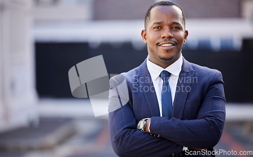 Image of Corporate, black man and smile in portrait with arms crossed in city, town or metro in government. African politician, happy and vision with motivation, professional confidence or leadership in suit