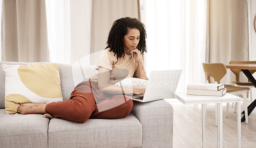 Image of Relax, laptop and woman on a sofa in a living room for news, social media or streaming in her home. Black woman, couch and online search for educational study, upskill and training tools in Africa