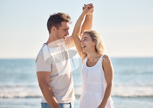 Image of Beach, love and dance with a young couple in nature, happy together during a date or summer vacation. Smile, travel and romance with a man and woman dancing by the sea or ocean while bonding