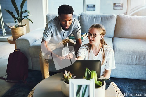 Image of Students, friends and laptop study at sofa for education, learning and elearning lecture discussion. Interracial, help and studying together online for university exam preparation in living room.