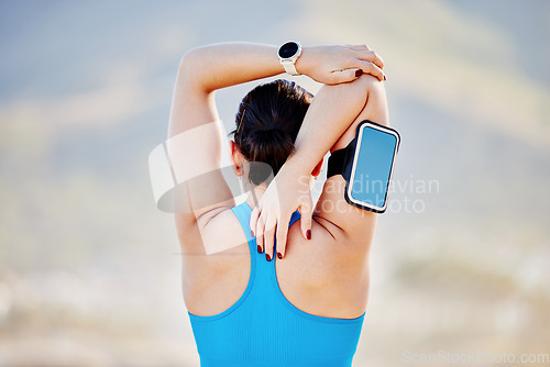 Image of Woman, stretching arms and back view in outdoor for fitness track on smartphone and healthcare exercise. Cardio training workout, sports motivation and athlete stretch body for runner performance