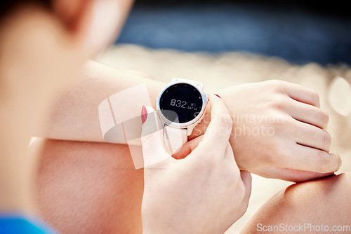 Image of Watch, time and exercise with a sports woman tracking her workout progress with a fitness app closeup. Smartwatch, data and tracker with a female athlete or runner timing her training session