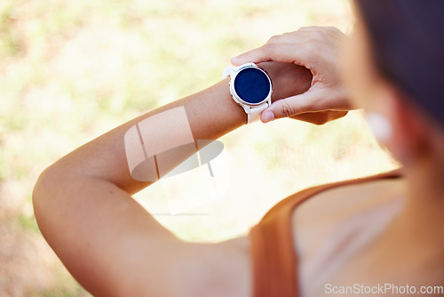 Image of Fitness, sports and woman with smartwatch on wrist with mockup screen for health tracking app. Digital tech, exercise and girl check results for running, training and workout performance in park