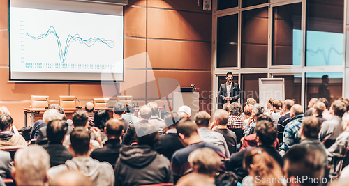 Image of Business speaker giving a talk in conference hall.