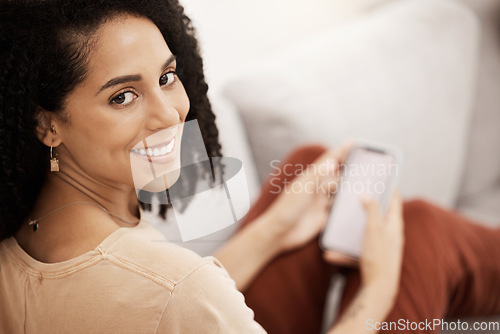 Image of Black woman, happy with smartphone and smile in portrait, relax on living room sofa with social media or texting. Communication, technology and online, relaxing at home with 5g network and mobile.