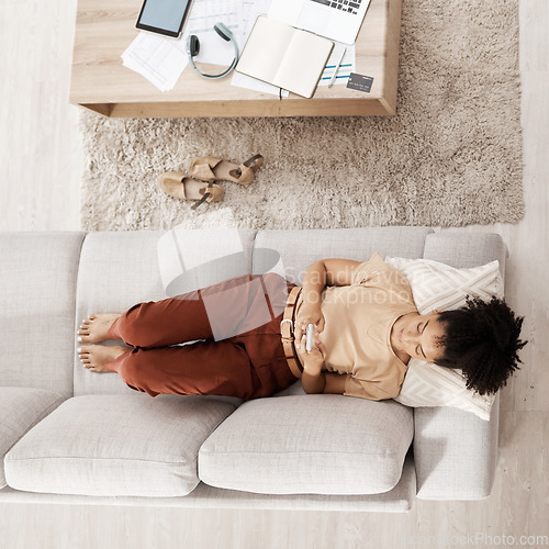Image of Black woman with smartphone, relax on couch and social media scroll overhead, taking break from work or study with communication and tech. Break, rest after bills or online shopping and mobile app