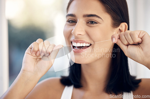 Image of Flossing, dental and woman teeth cleaning for healthcare and wellness in a home bathroom. Healthy smile and dentist care of a person with happiness from dental care and teeth whitening results